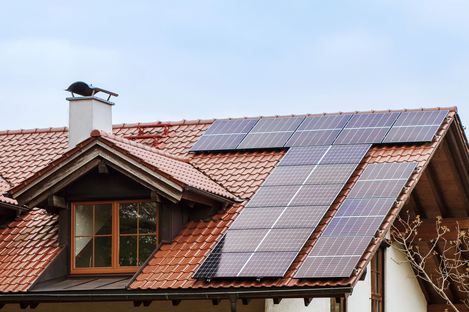 Solar panels on the tiled roof of a house.