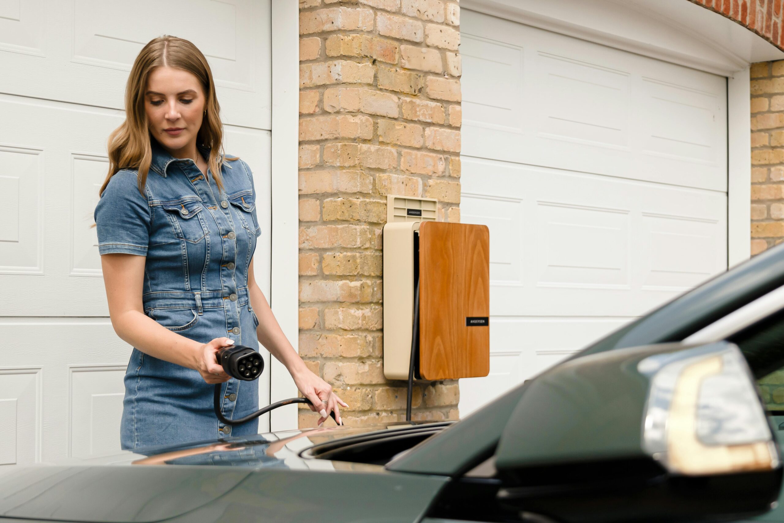 Woman Pre Plug In A woman is about to plug in an EV charger.