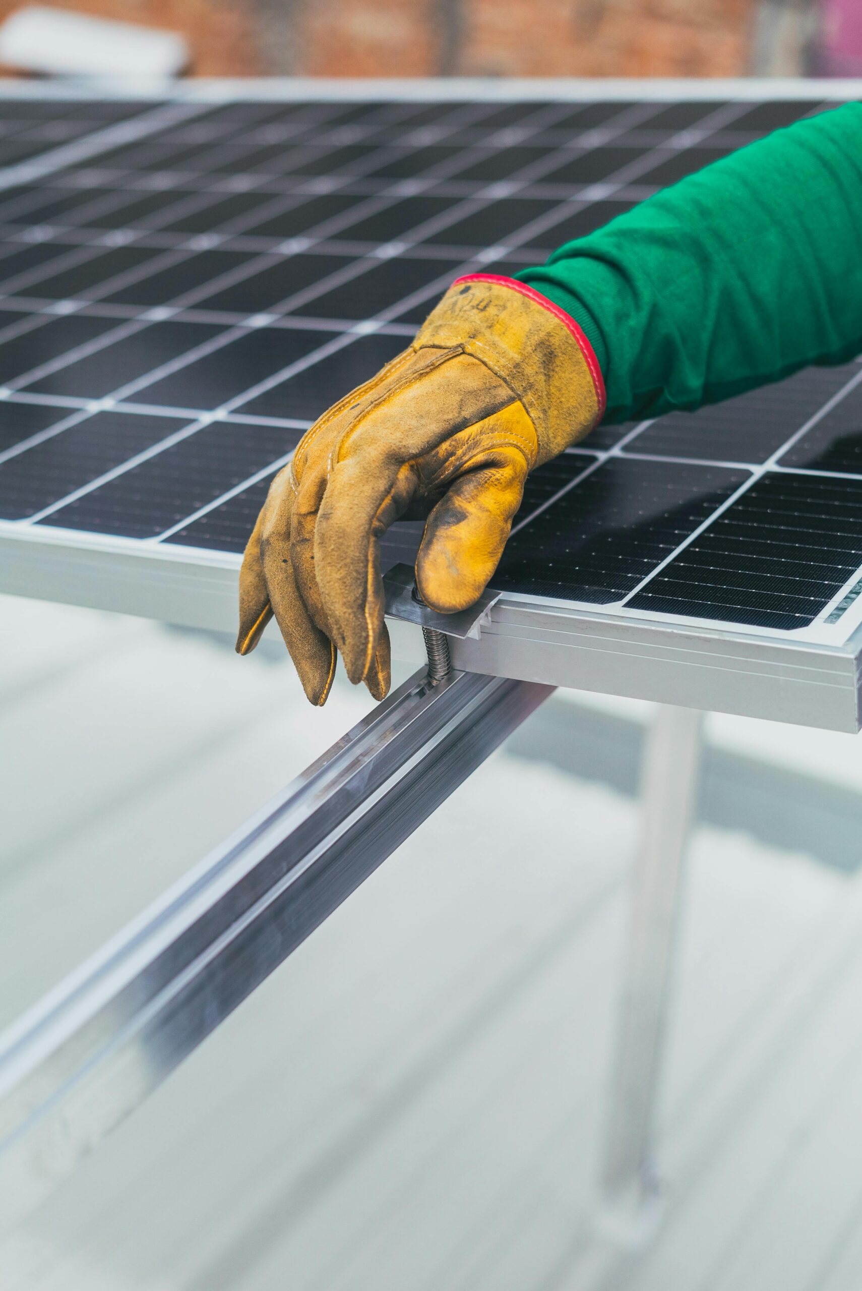 Hand Rest Installed Panel A hand resting against an installed solar panel.