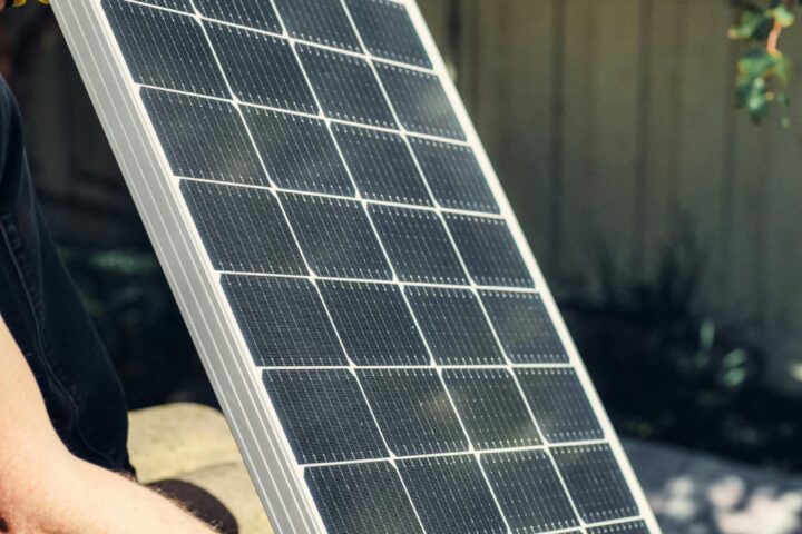 A man holding a solar panel.