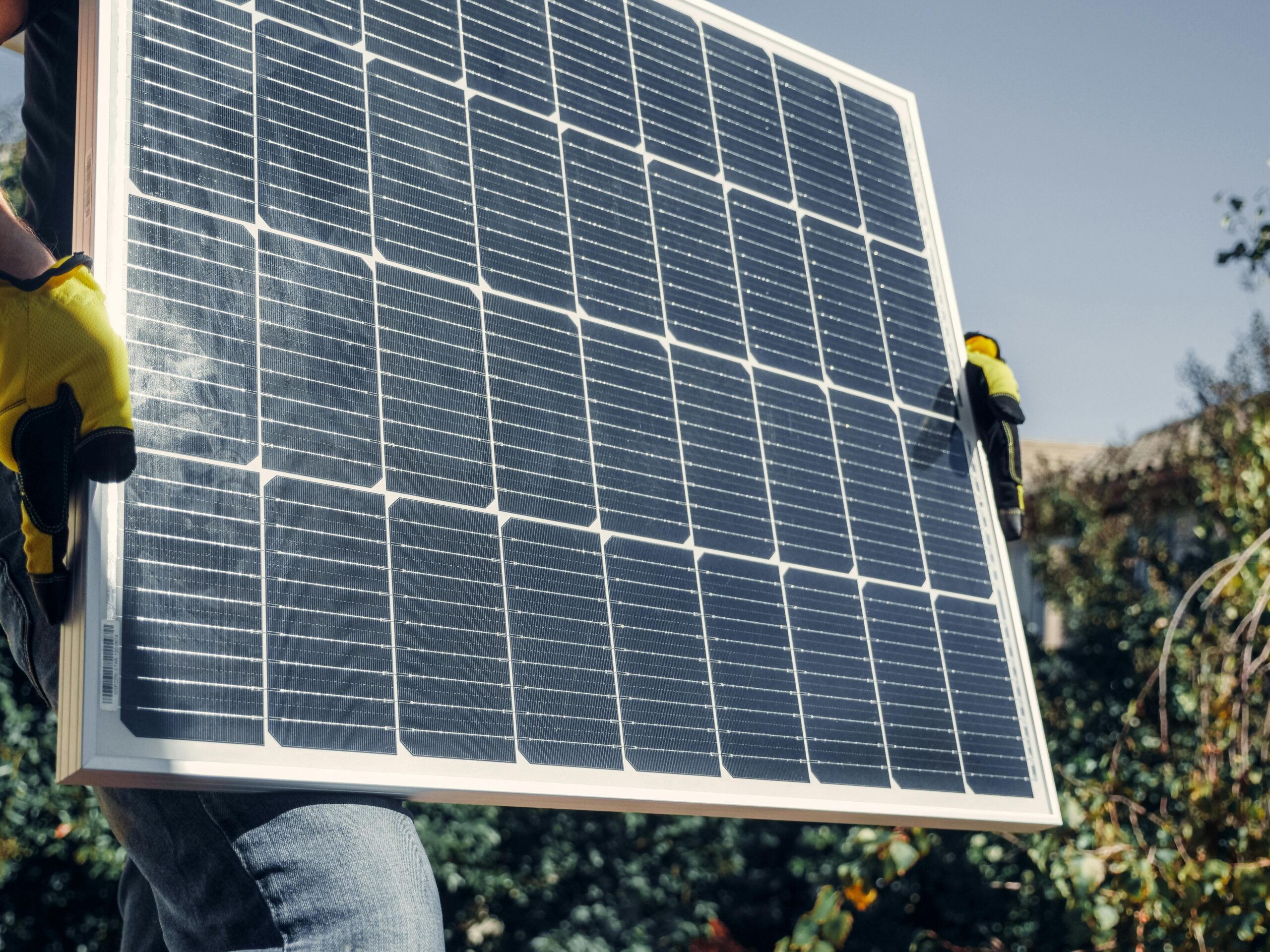Holding Up Solar Panel Holding up a solar panel ready for installation.