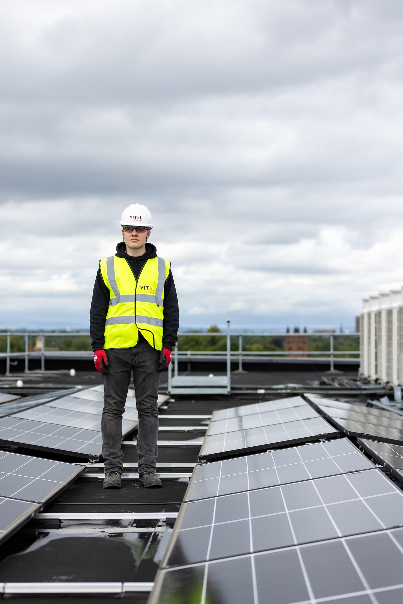 Another Man in a high vis with lots of solar panels.