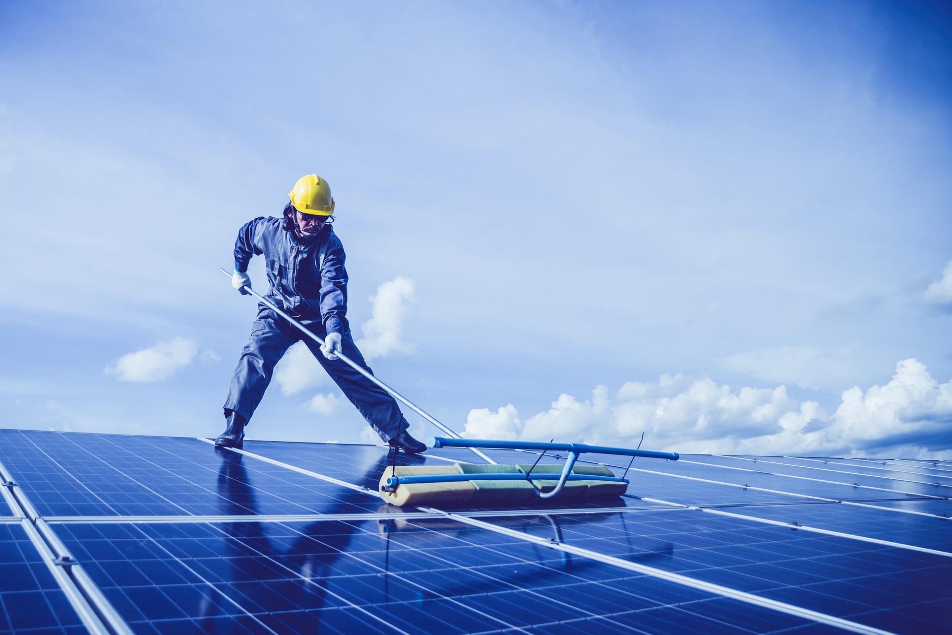 A man cleaning solar panels.