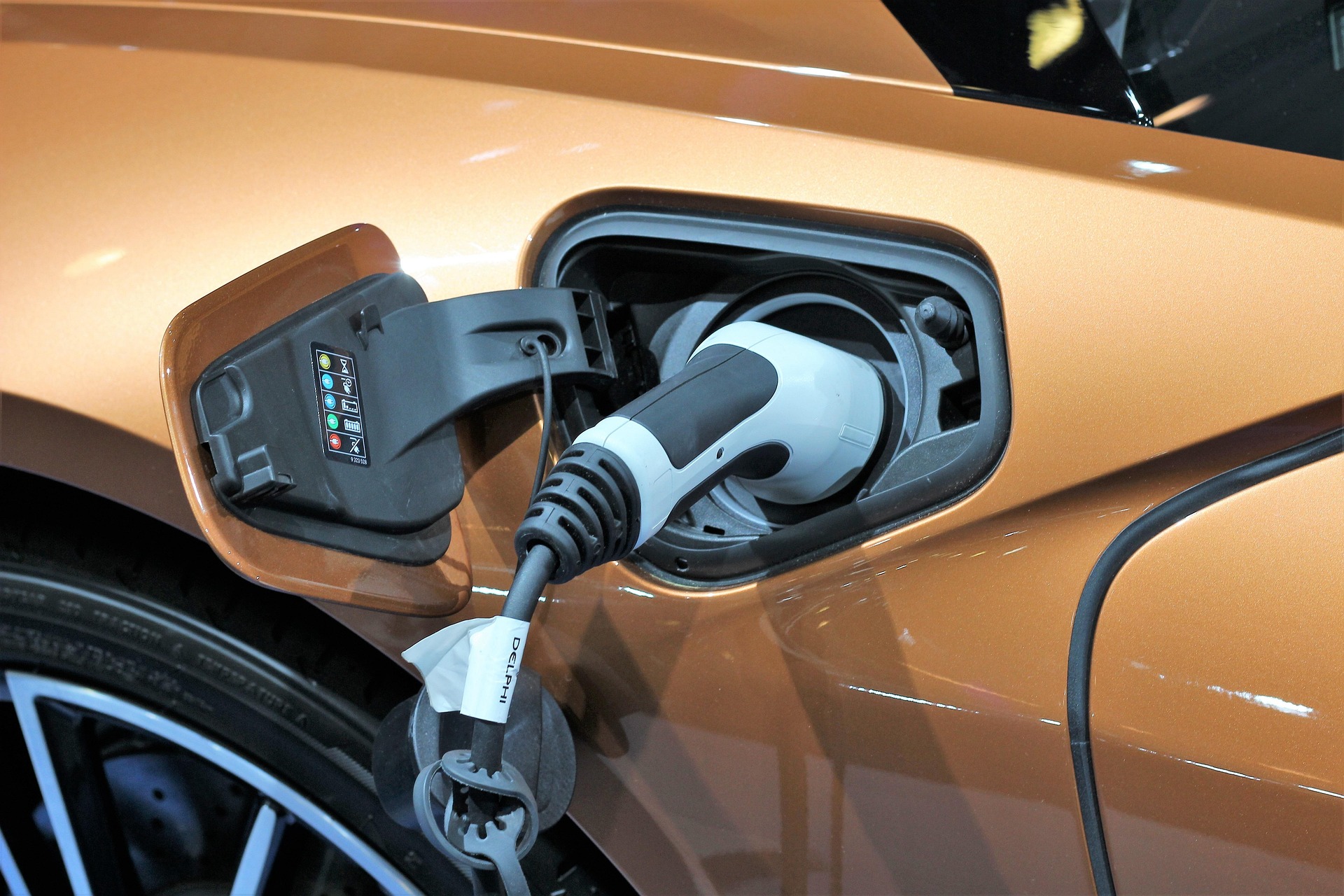 An orange EV on charge.