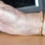 An old person holding their smart meter in the cost of living crisis.