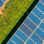 A solar farm with solar panels in a green field.