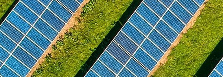 A solar farm with solar panels in a green field.