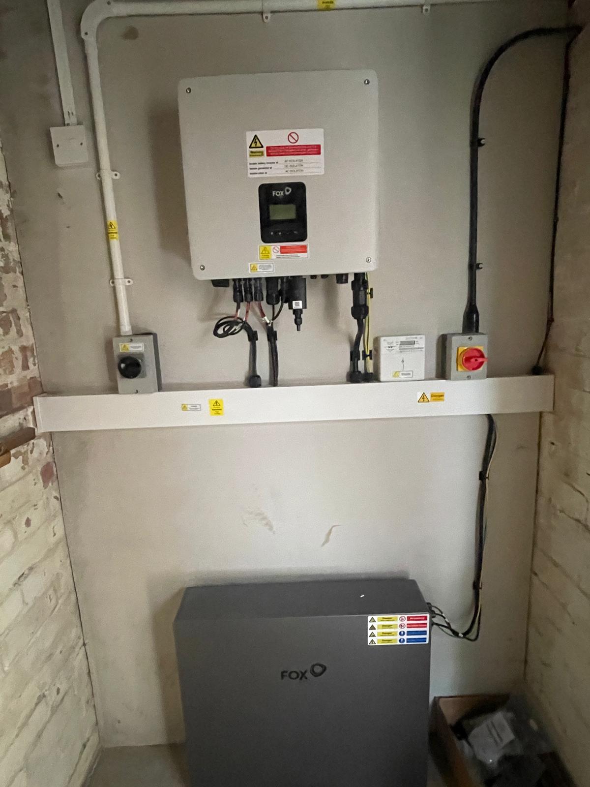 Solar Battery Installed On A Wall With Wires Showing.