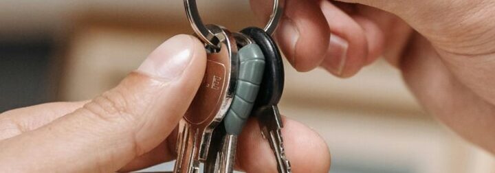A landlord handing over the keys to a property.