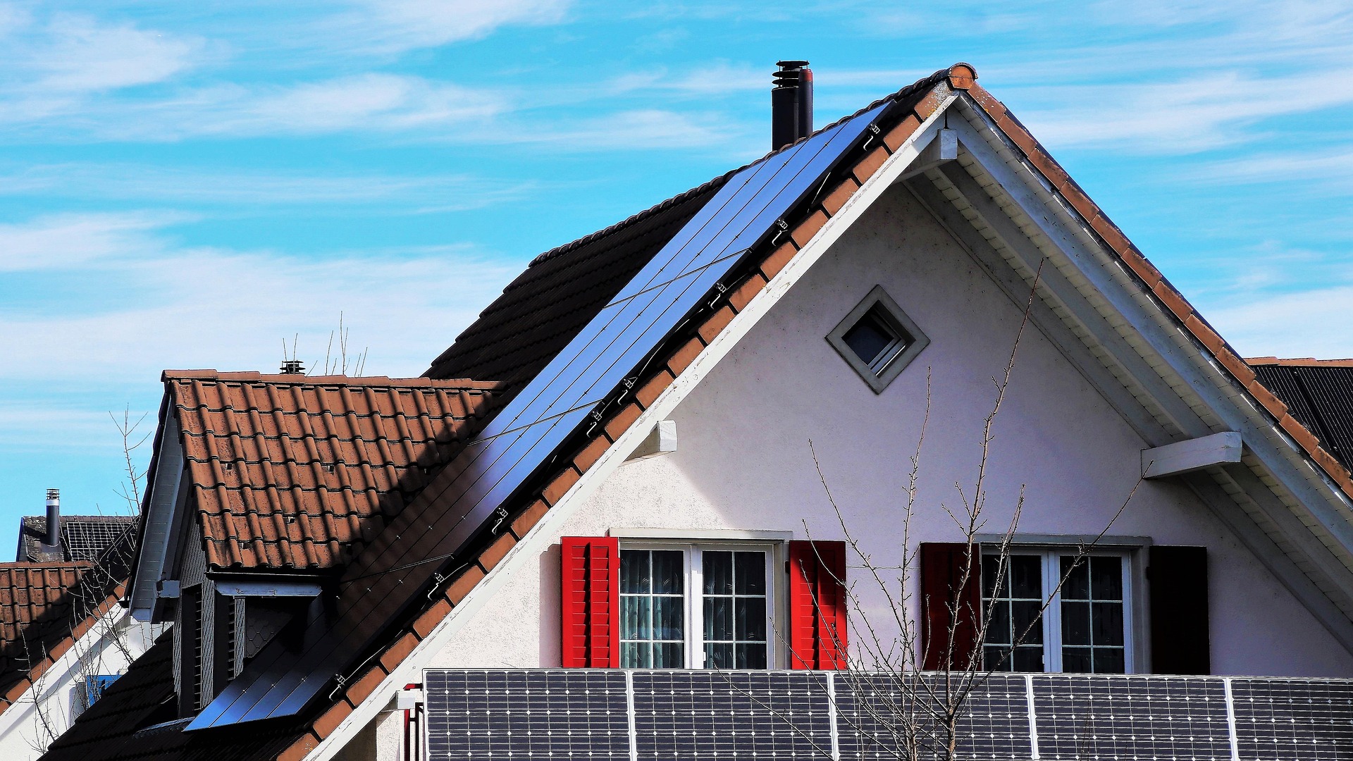 Solar panels on a white painted house.