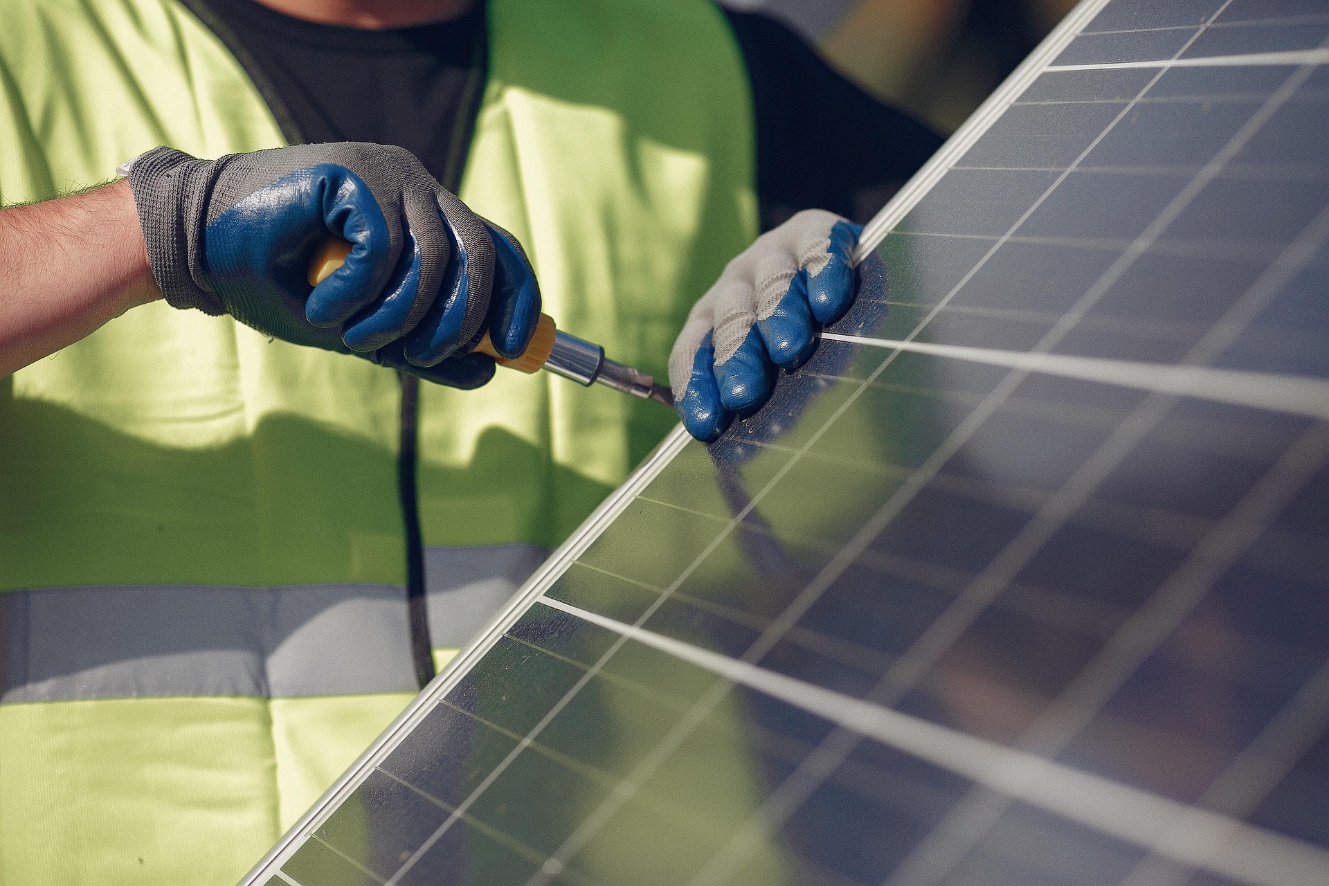 A man installing a solar panel.