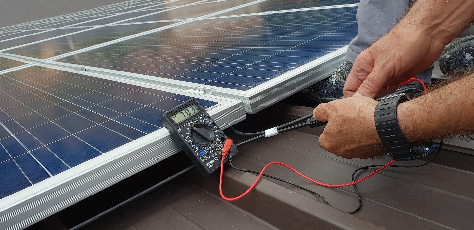 A man cleaning solar panels.