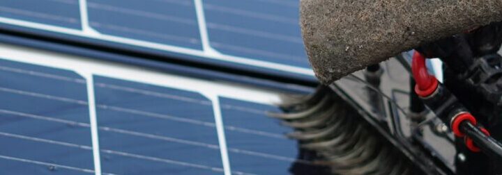 Cleaning solar panels on a roof.