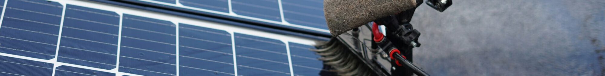 Cleaning solar panels on a roof.