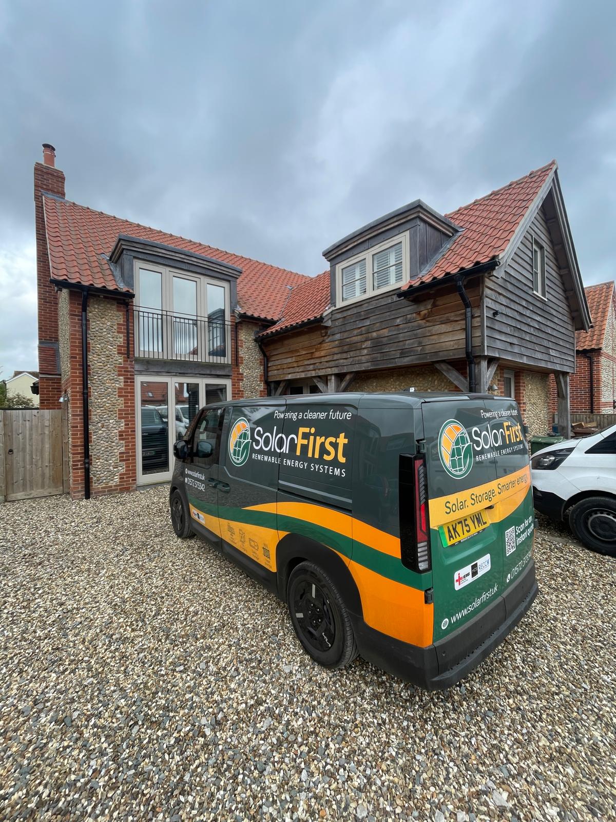 Solar First Van on the driveway of a house.