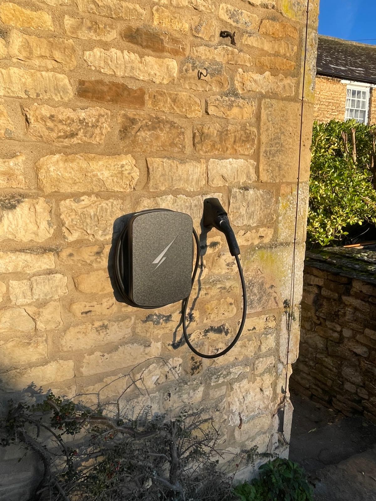 An ev wall charger on the side of a house in Leicestershire.