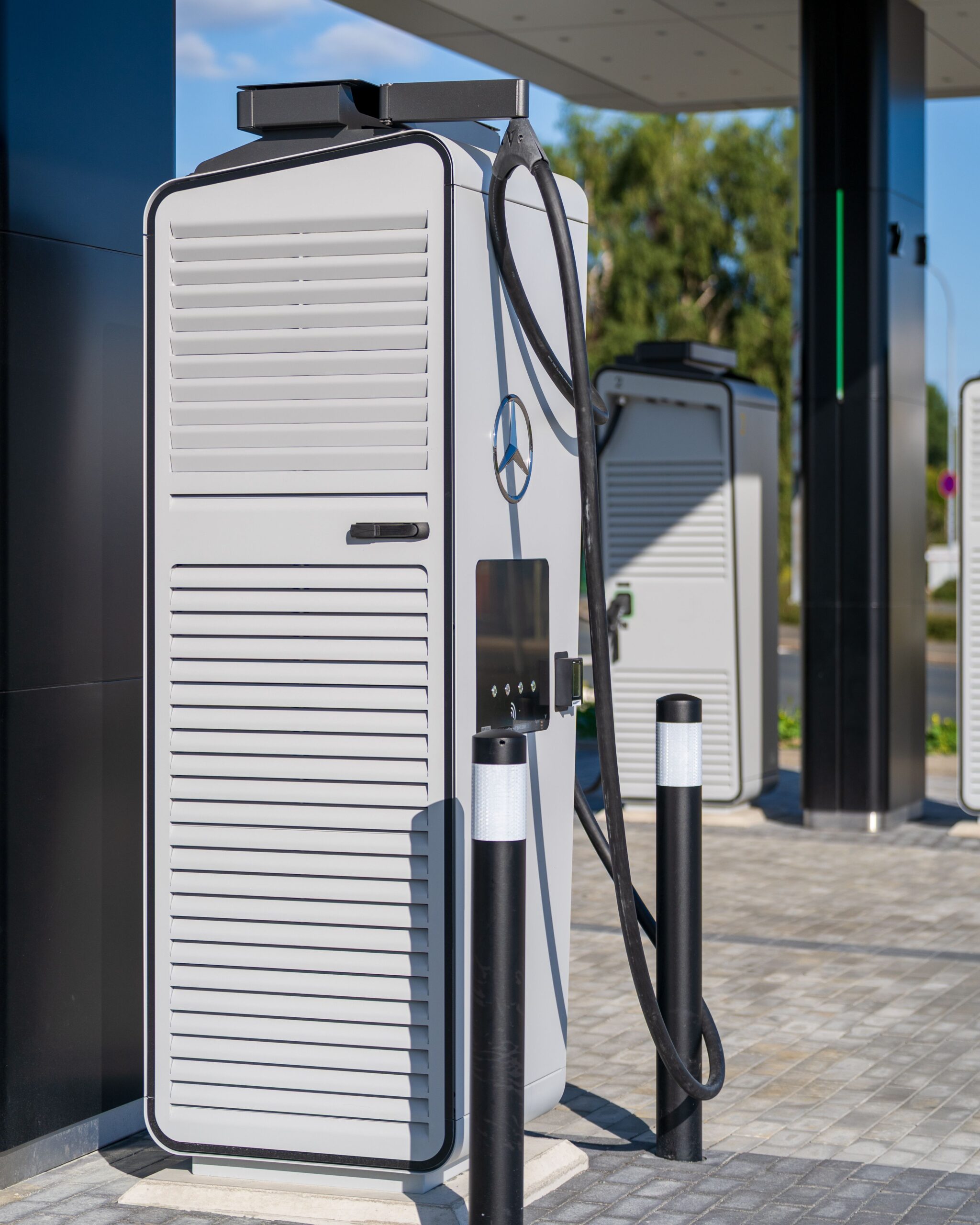 A sleek electric vehicle charging station under a clear blue sky, showcasing modern infrastructure.