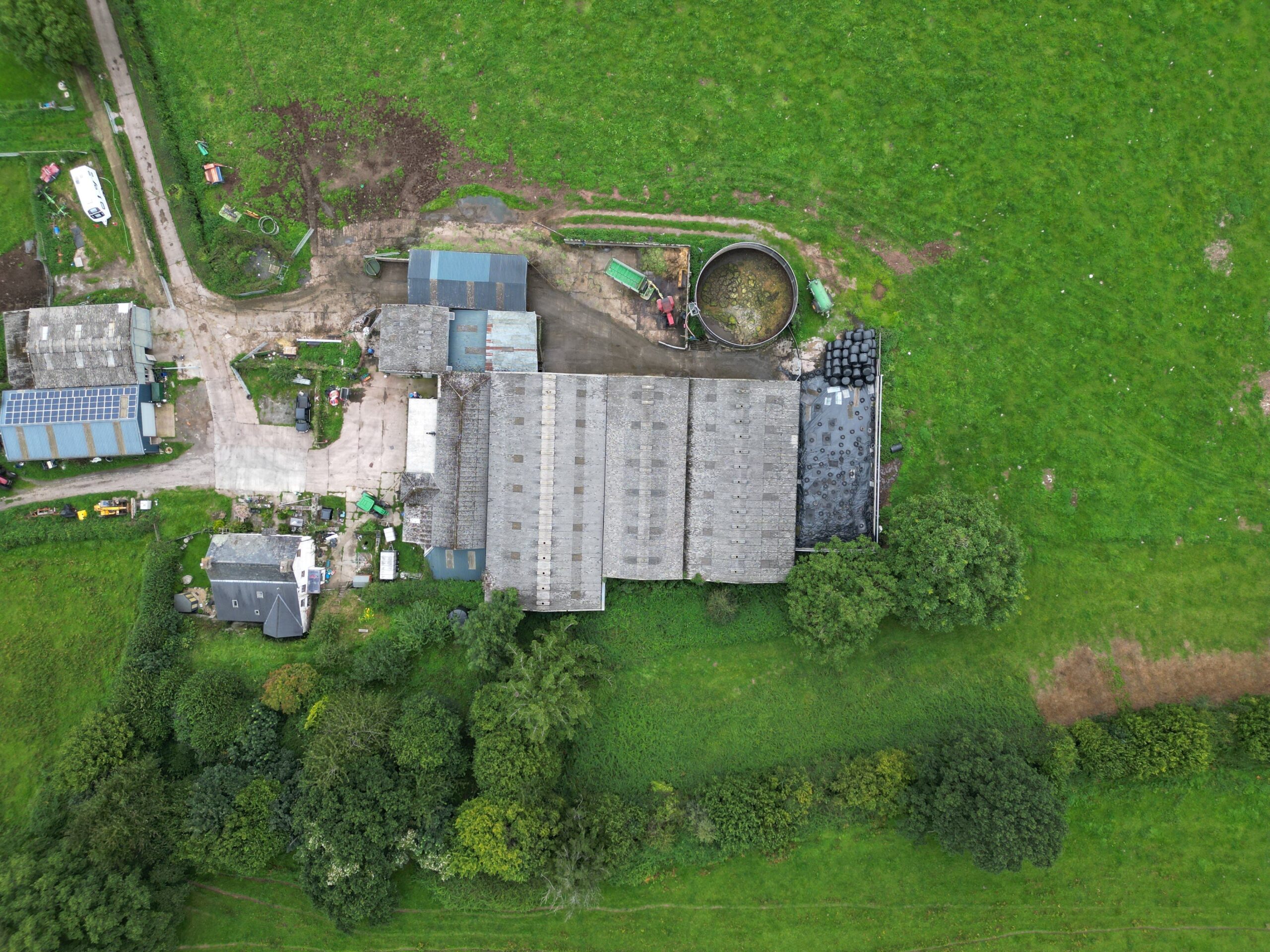 Aerial shot of a farm in Crickhowell, displaying lush green fields and rural structures